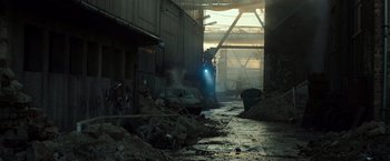 Movie still from “Spectral” (2016), directed by Nic Mathieu – A car is parked in the middle of a dirty street; Extreme Wide shot, High angle
