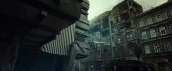 Movie still from “Spectral” (2016), directed by Nic Mathieu – An old building with a bunch of buildings in the background; Extreme Wide shot, Low angle