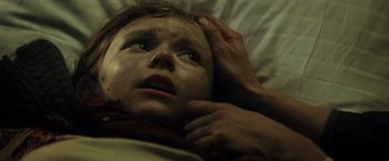 Movie still from “Spectral” (2016), directed by Nic Mathieu – A person laying on a bed; Close Up shot, High angle