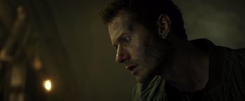 Movie still from “Spectral” (2016), directed by Nic Mathieu – A person looking at the camera; Close Up shot, Low angle