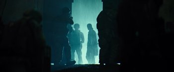 Movie still from “Spectral” (2016), directed by Nic Mathieu – A group of men standing in front of a wall; Wide shot, Low angle