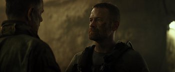 Movie still from “Spectral” (2016), directed by Nic Mathieu – A person wearing a helmet; Close Up shot, Over the shoulder angle