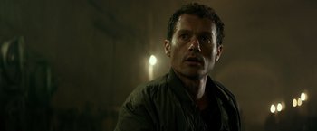 Movie still from “Spectral” (2016), directed by Nic Mathieu – A person wearing a jacket; Close Up shot, Low angle