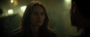 Movie still from “Spectral” (2016), directed by Nic Mathieu – A person with long brown hair; Close Up shot, Over the shoulder angle
