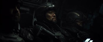 Movie still from “Spectral” (2016), directed by Nic Mathieu – A person wearing a helmet; Close Up shot, Low angle