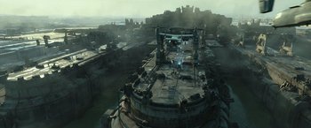 Movie still from “Spectral” (2016), directed by Nic Mathieu – An aerial view of an abandoned ship in the middle of the ocean; Extreme Wide shot, High angle