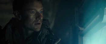 Movie still from “Spectral” (2016), directed by Nic Mathieu – A person wearing a leather jacket; Close Up shot, Low angle