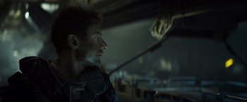 Movie still from “Spectral” (2016), directed by Nic Mathieu – A person in a dark room; Close Up shot, Low angle