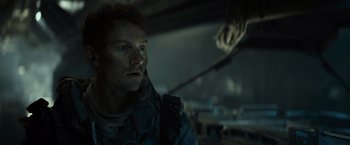 Movie still from “Spectral” (2016), directed by Nic Mathieu – A person in a dark room; Close Up shot, Low angle