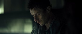 Movie still from “Spectral” (2016), directed by Nic Mathieu – A person sitting down with his eyes closed; Close Up shot, Low angle