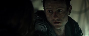 Movie still from “Spectral” (2016), directed by Nic Mathieu – A person wearing a leather jacket; Close Up shot, Over the shoulder angle