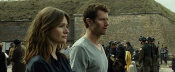 Movie still from “Spectral” (2016), directed by Nic Mathieu – A man and a woman standing next to each other; Close Up shot, Over the shoulder angle