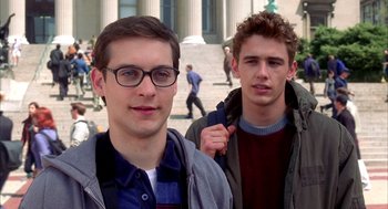 Movie still from “Spider-Man” (2002), directed by Sam Raimi – Two young men standing next to each other on the street; Close Up shot, Low angle