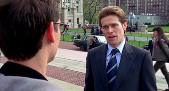 Movie still from “Spider-Man” (2002), directed by Sam Raimi – A man wearing a suit and tie talking to another man in a suit; Close Up shot, Over the shoulder angle