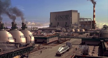 Movie still from “Spider-Man” (2002), directed by Sam Raimi – An oil refinery with a bus parked in front of it; Extreme Wide shot, Low angle
