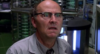 Movie still from “Spider-Man” (2002), directed by Sam Raimi – An older man wearing glasses and a lab coat; Close Up shot, Low angle