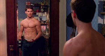 Movie still from “Spider-Man” (2002), directed by Sam Raimi – A man looking at himself in the mirror in front of a mirror; Medium shot, Over the shoulder angle
