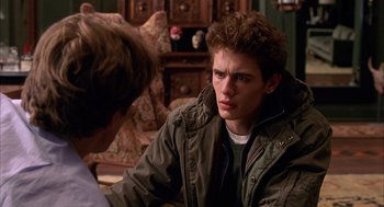 Movie still from “Spider-Man” (2002), directed by Sam Raimi – A young man sitting in front of another young man; Close Up shot, Over the shoulder angle