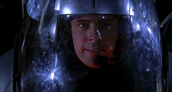 Movie still from “Spider-Man” (2002), directed by Sam Raimi – A man wearing a helmet in the rain; Close Up shot, Overhead angle