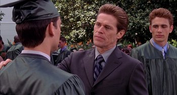 Movie still from “Spider-Man” (2002), directed by Sam Raimi – A person wearing a suit and tie; Close Up shot, Over the shoulder angle
