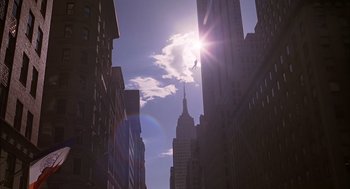 Movie still from “Spider-Man” (2002), directed by Sam Raimi – The sun is shining in the middle of a city; Extreme Wide shot, Low angle