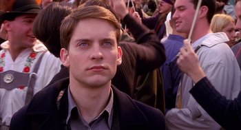 Movie still from “Spider-Man” (2002), directed by Sam Raimi – A person wearing a suit and tie; Close Up shot, High angle