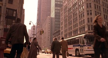 Movie still from “Spider-Man” (2002), directed by Sam Raimi – A group of people standing on the side of a road; Wide shot, Low angle