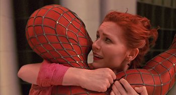 Movie still from “Spider-Man” (2002), directed by Sam Raimi – A woman hugging a man in a spider man costume; Close Up shot, Over the shoulder angle