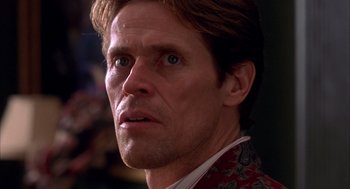 Movie still from “Spider-Man” (2002), directed by Sam Raimi – A person wearing a suit; Close Up shot, Low angle