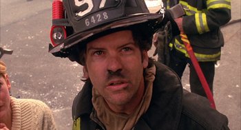 Movie still from “Spider-Man” (2002), directed by Sam Raimi – A man in a fireman's uniform with a helmet on his head; Close Up shot, Low angle