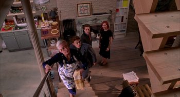 Movie still from “Spider-Man” (2002), directed by Sam Raimi – An older woman and two young boys on a staircase; Wide shot, High angle