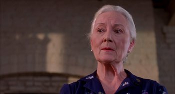 Movie still from “Spider-Man” (2002), directed by Sam Raimi – An older woman with white hair looking at the camera; Close Up shot, Low angle