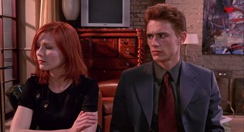 Movie still from “Spider-Man” (2002), directed by Sam Raimi – A man and a woman sitting in front of each other in a room; Close Up shot, Over the shoulder angle
