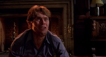 Movie still from “Spider-Man” (2002), directed by Sam Raimi – A person sitting in front of a fire place; Close Up shot, Low angle