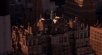 Movie still from “Spider-Man” (2002), directed by Sam Raimi – An aerial view of a city at night with buildings; Extreme Wide shot, Overhead angle