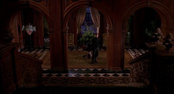 Movie still from “Spider-Man” (2002), directed by Sam Raimi – A man standing in the middle of a room; Wide shot, High angle