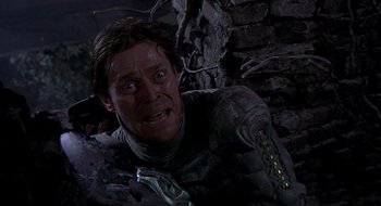 Movie still from “Spider-Man” (2002), directed by Sam Raimi – A man in a space suit sitting in a cave; Close Up shot, High angle