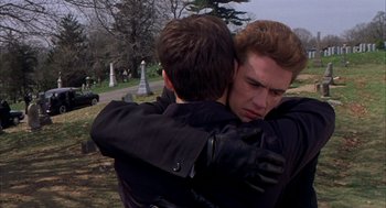 Movie still from “Spider-Man” (2002), directed by Sam Raimi – Two young men hugging each other in a cemetery; Close Up shot, Over the shoulder angle
