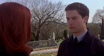 Movie still from “Spider-Man” (2002), directed by Sam Raimi – A man and a woman standing next to each other in a cemetery; Close Up shot, Over the shoulder angle