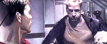 Movie still from “Spider-Man 2” (2004), directed by Sam Raimi – A man holding a cell phone while sitting on a chair; Extreme Close Up shot, Over the shoulder angle