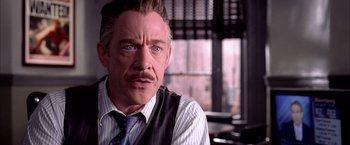 Movie still from “Spider-Man 2” (2004), directed by Sam Raimi – A person wearing a suit and tie; Close Up shot, Over the shoulder angle