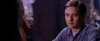 Movie still from “Spider-Man 2” (2004), directed by Sam Raimi – A man sitting in front of a brick wall; Close Up shot, Over the shoulder angle