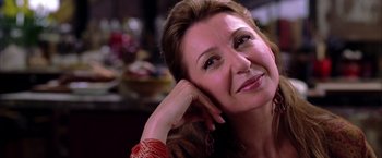 Movie still from “Spider-Man 2” (2004), directed by Sam Raimi – A person sitting with her hand on her head; Close Up shot, Over the shoulder angle