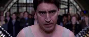 Movie still from “Spider-Man 2” (2004), directed by Sam Raimi – A person's face in a crowd of onlookers; Close Up shot, Low angle