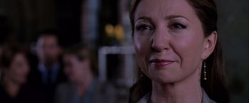 Movie still from “Spider-Man 2” (2004), directed by Sam Raimi – A woman's face in a dark room; Close Up shot, Over the shoulder angle