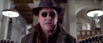 Movie still from “Spider-Man 2” (2004), directed by Sam Raimi – A person wearing sunglasses and a hat; Close Up shot, Low angle