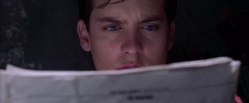 Movie still from “Spider-Man 2” (2004), directed by Sam Raimi – A person reading a newspaper; Close Up shot, Overhead angle