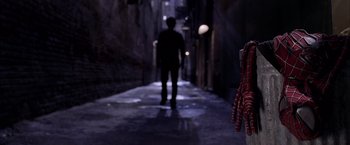 Movie still from “Spider-Man 2” (2004), directed by Sam Raimi – A man walking down a dark street at night; Wide shot, Over the shoulder angle