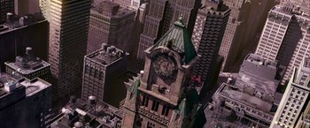 Movie still from “Spider-Man 2” (2004), directed by Sam Raimi – An aerial view of a clock tower in a city; Extreme Wide shot, Overhead angle