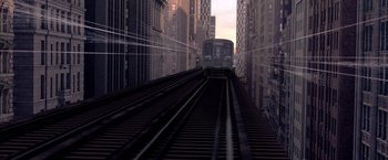 Movie still from “Spider-Man 2” (2004), directed by Sam Raimi – A train traveling down the tracks through a city; Extreme Wide shot, Overhead angle